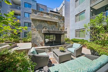 Mingle: courtyard with outdoor fireplace, water feature, and bbq grills